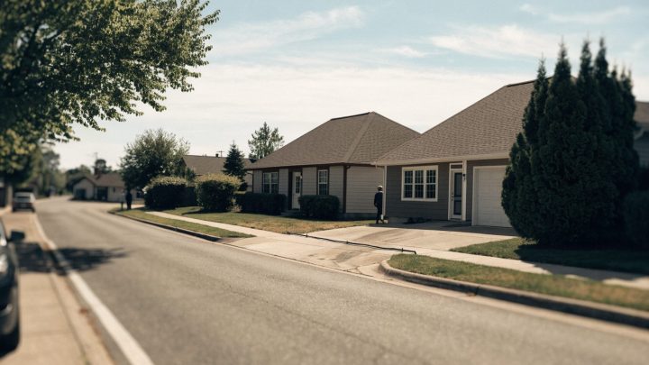 Two adjacent suburban houses with a shared driveway between them